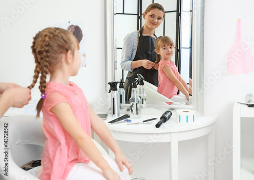 Cute little girl in hairdre...