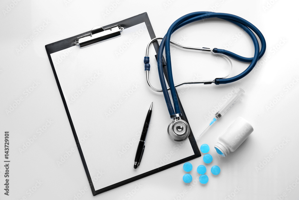 Cough drops, clipboard and medical equipment on white background Cough drops, clipboard and medical equipment on white background