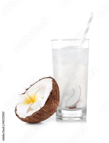 Glass of coconut water and fresh nut on white background