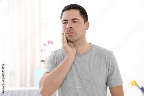 Man suffering from toothach...