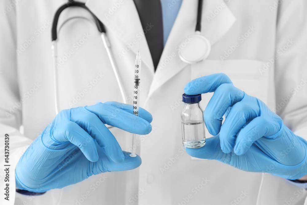Doctor with syringe and medicine for vaccination, closeup Doctor with syringe and medicine for vaccination, closeup