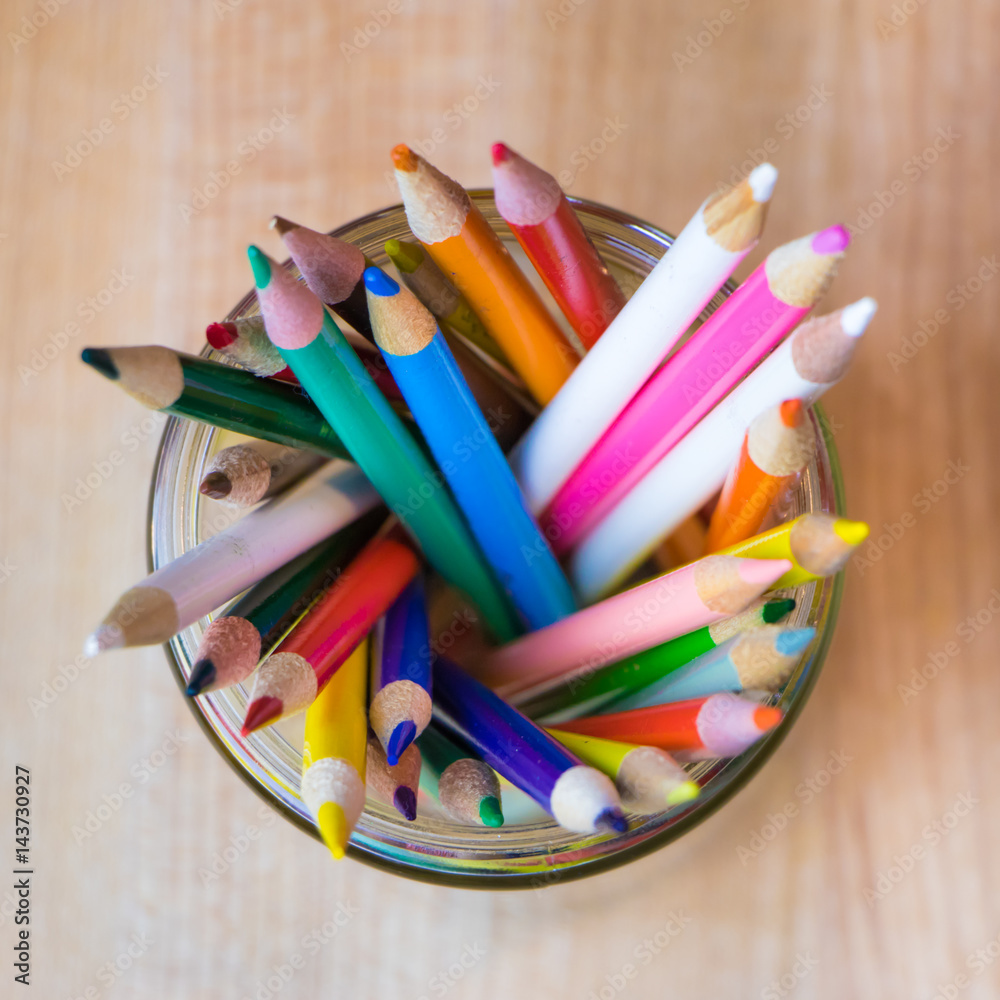 Fototapeta premium Colored pencils in a jar from above