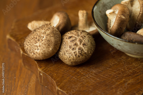 Shiitake mushrooms on a wooden table. Selective focus