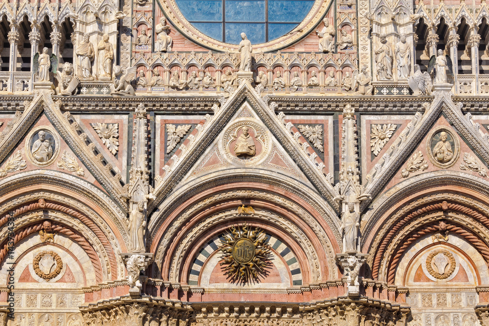 The beautiful marble West facade of the Cathedral Duomo in Siena, Italy