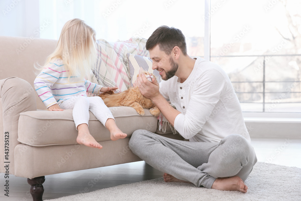Father and his daughter with cat at home Father and his daughter with cat at home
