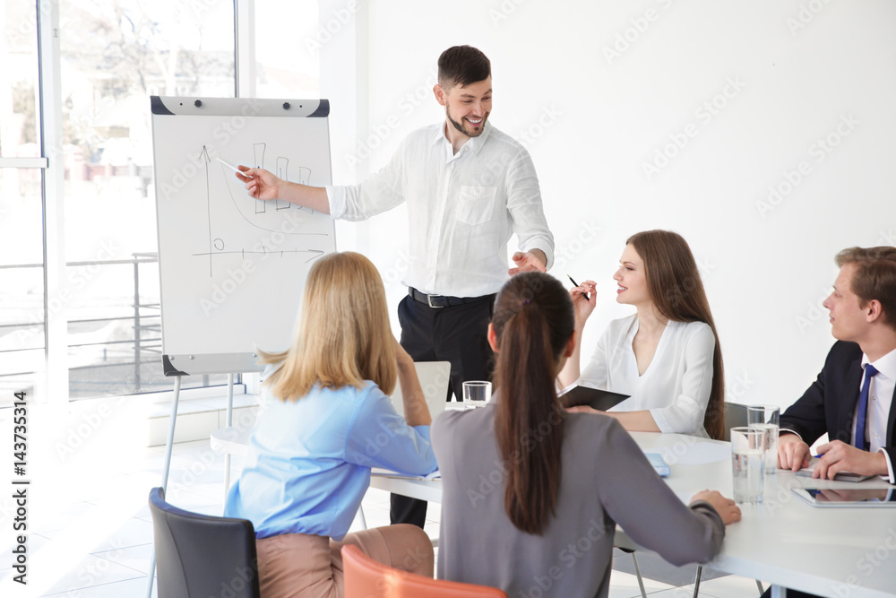 Business trainer giving presentation to group of people Business trainer giving presentation to group of people