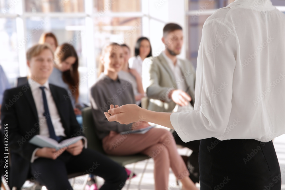 Business trainer giving presentation to group of people Business trainer giving presentation to group of people