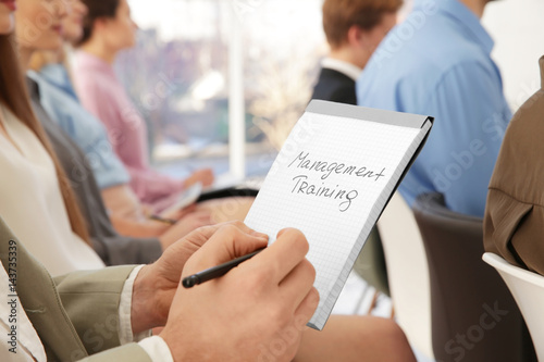 Man holding notebook with t...
