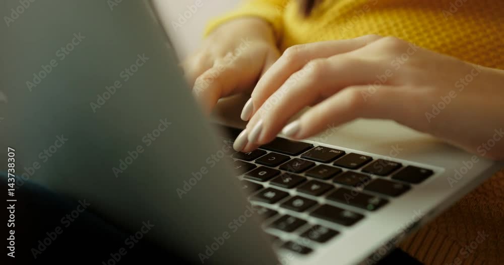 Close up woman hands typing on laptop keyboard indoor. Close-up fingers typing on keyboard