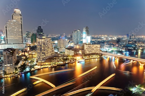 Photography Aerial panorama of Bangkok in evening twilight with busy traffic on Taksin Bridg