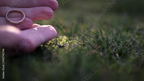 Fantasy film concept - A strange man snatches a golden ring from the grass photo