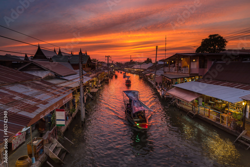 Sunset and Boat on canal with old market, this lace is call Ampawa floating market, SamuthsongkramThailand