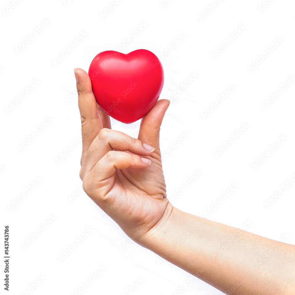 hand holding a red heart on white background