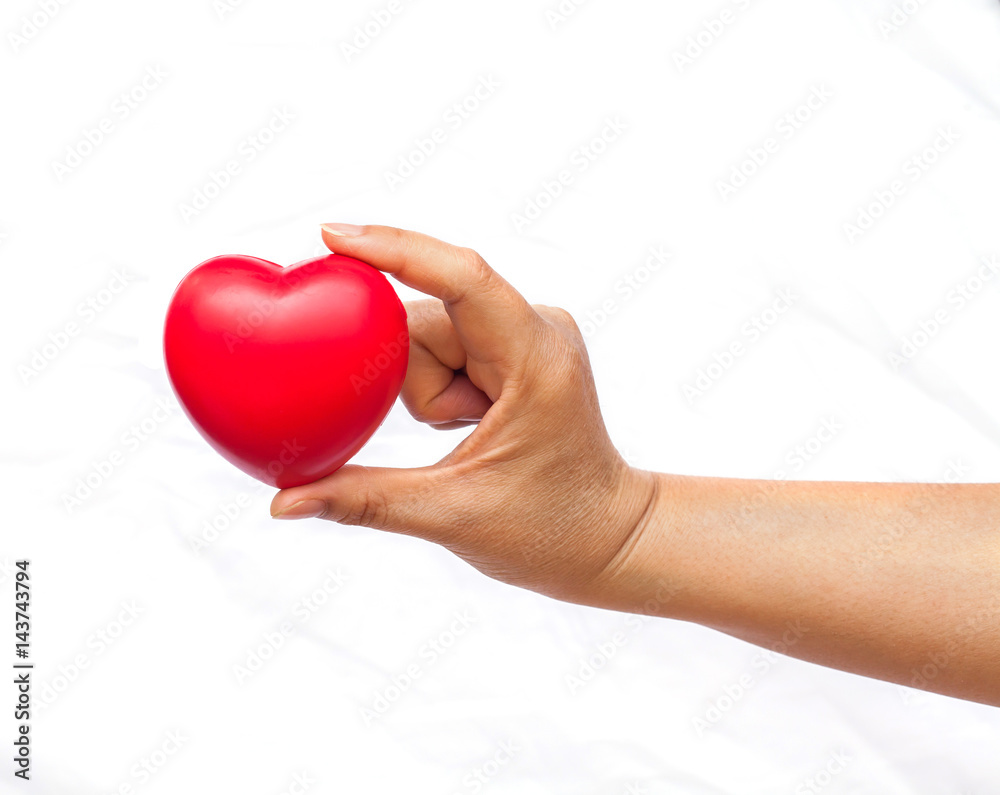 hand holding a red heart on white background