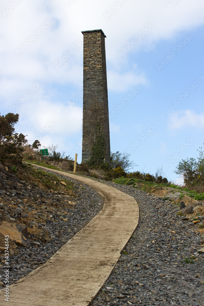 The old industrial chimney from the 19th century South Engine House at the derelict lead mines workings in Conlig in County Down, Northern Ireland
