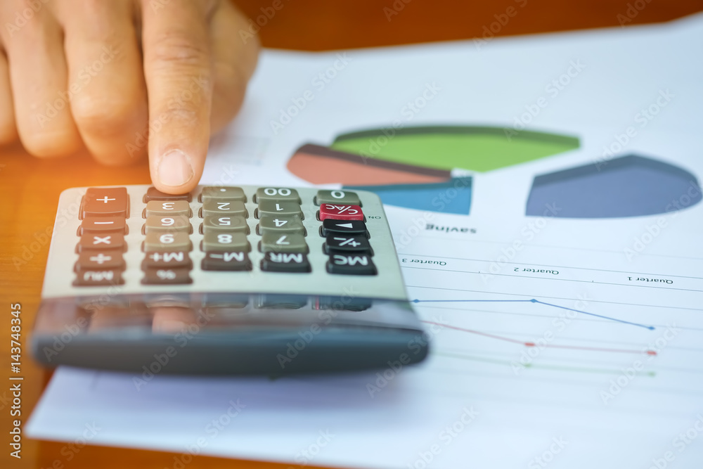 Concept businness,Coin and calculator placed on the graph. Concept businness,Coin and calculator placed on the graph.