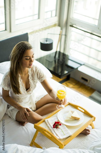 Young woman having breakfas...