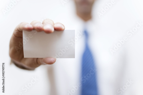 Businessman holding white business card in his hand