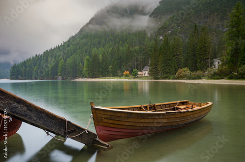 Cloudy and foggy morning on the alpine lake Lago di Braies  dolomites  italy