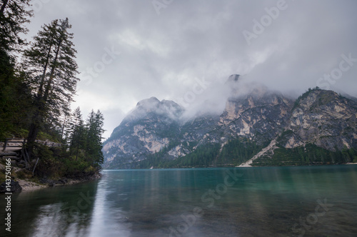 Cloudy and foggy morning on the alpine lake Lago di Braies, dolomites, italy © Mike Mareen