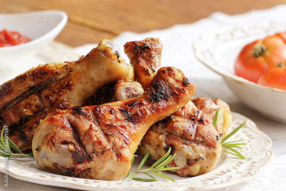 Grilled chicken legs with rosemary on table Grilled chicken legs with rosemary on table