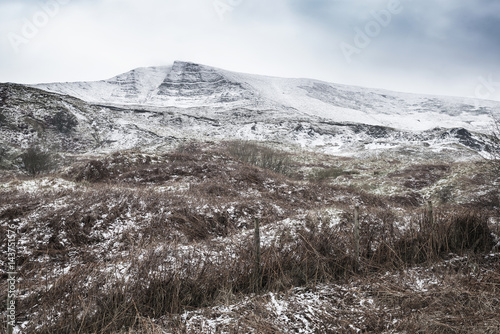 Beautiful Winter landscape image around Mam Tor countryside in Peak District England photo