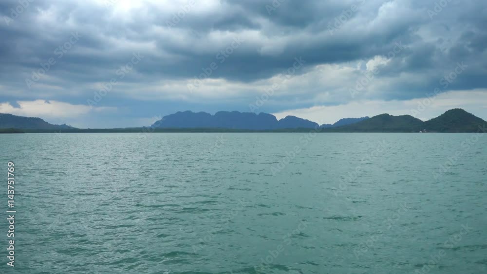 View from moving boat on islands and moody sky, Thailand, 4k
