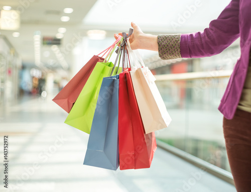 Crop faceless woman holding shopping bags