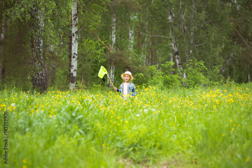 cute little girl runs through a beautiful meadow in the woods.