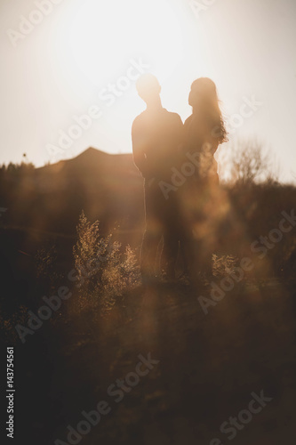 Husband and wife in nature, early spring. Happy couple on vacation. Lovers are laughing. guy and girl. enjoy each other in the evening park.