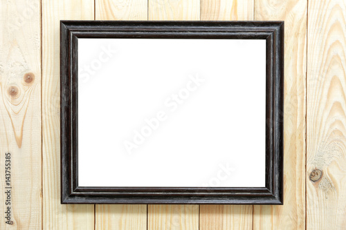 Black wood frame on wooden floor.