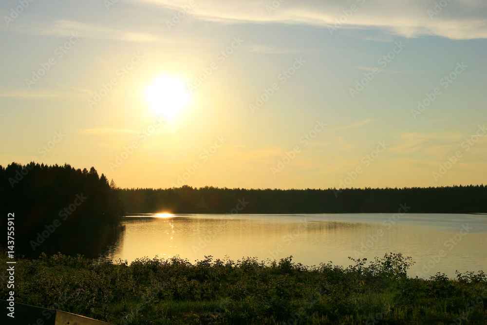 Sunset on the shore of a forest lake