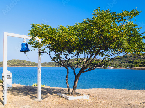 Traditional small lonely bell with tree on the beach. Greece. Halkidiki. Pefkohori. photo