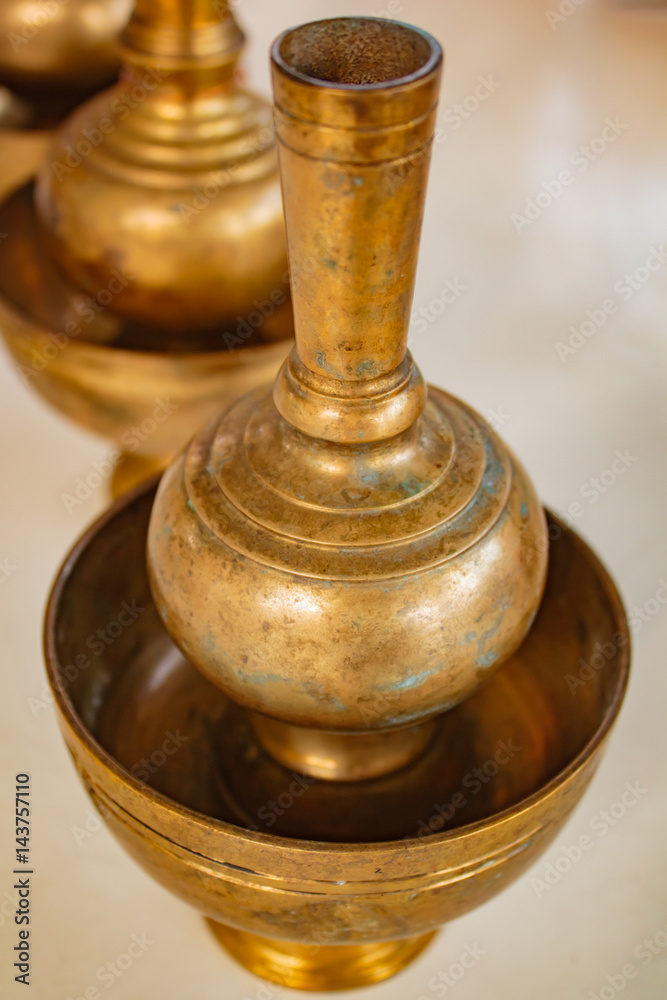A golden brass pour ceremonial water jar. A golden brass pour ceremonial water jar.