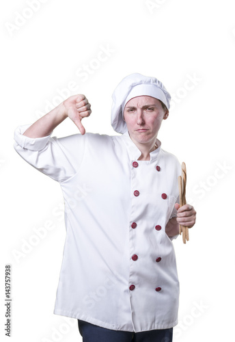 Nice young woman chef with thumb down and wood utensils