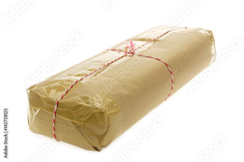 Parcel wrapped with brown kraft paper isolated on white background.