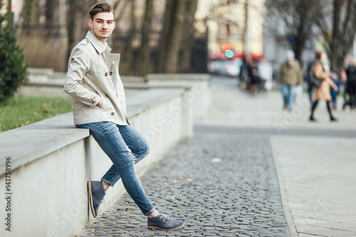 Fashionable man standing outdoors with white background