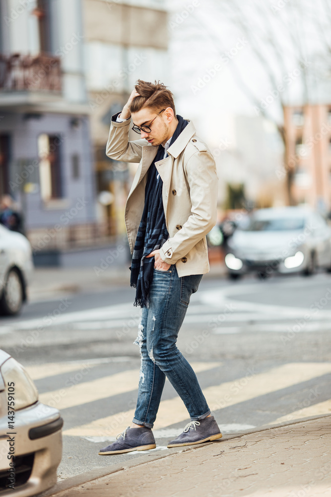 Fashionable man walking on the street with blur background Fashionable man walking on the street with blur background