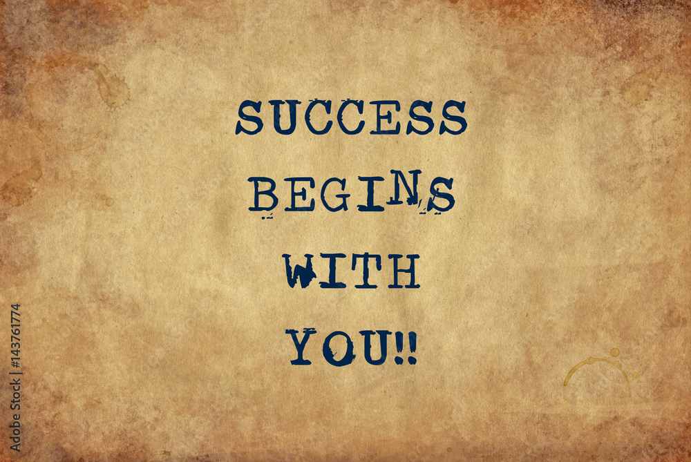 Inspiring motivation quote of success begins with you with typewriter text. Distressed Old Paper with Typing image.
