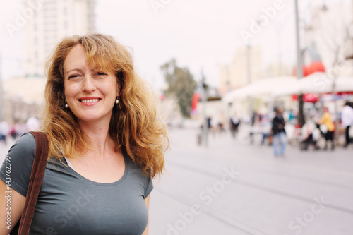 Portrait of smiling 40 years old woman outdoors