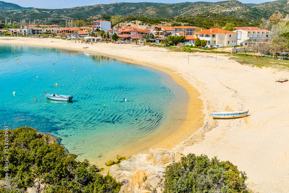 Summer day in Kalamitsi beach. Colorful Greek fishing boats in the natural bay. Typical Greek landscape from Kalamitsi, Sitonia, Halkidiki, Macedonia, Northern Greece.