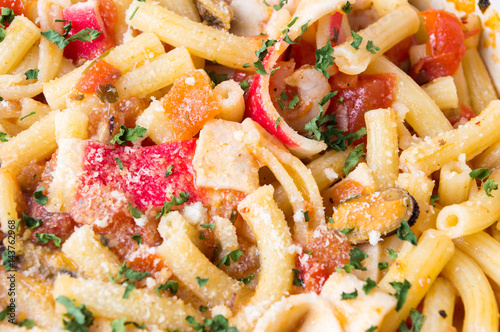 Pasta with seafood and tomato background