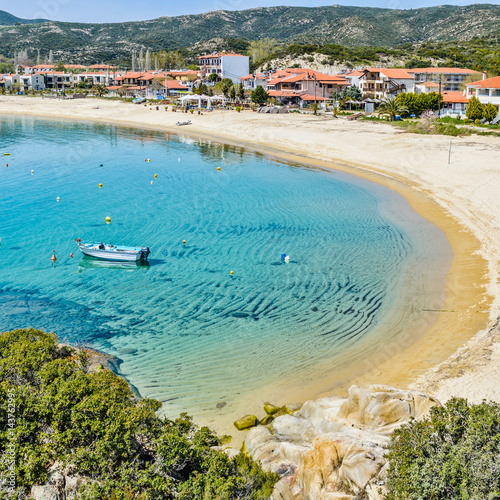 Obraz na płótnie Summer day in Kalamitsi beach. Colorful Greek fishing boats in the natural bay. Typical Greek landscape from Kalamitsi, Sitonia, Halkidiki, Macedonia, Northern Greece. w salonie