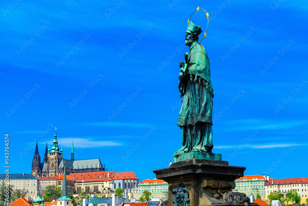 Fototapeta premium Statue of John of Nepomuk (Jan Nepomucky) on Charles Bridge in Prague, Czech Republic