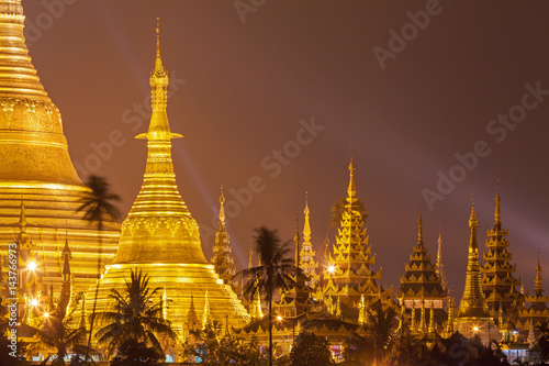 Yangon, Myanmar view of Shwedagon Pagoda at night with spotlight reflects gold surface of The pagoda photo