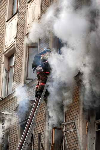 Fireman extinguishes a fire in an apartment building