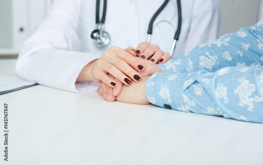 Friendly female doctor's hands holding male patient's hand for encouragement and empathy. Partnership trust and medical ethics concept. Friendly female doctor's hands holding male patient's hand for encouragement and empathy. Partnership trust and medical ethics concept.