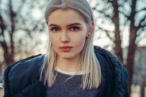 Beautiful attractive young girl in the evening in the city