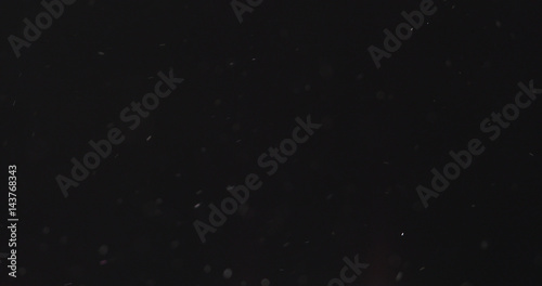 dust particles fast moving over black background from right  4k photo