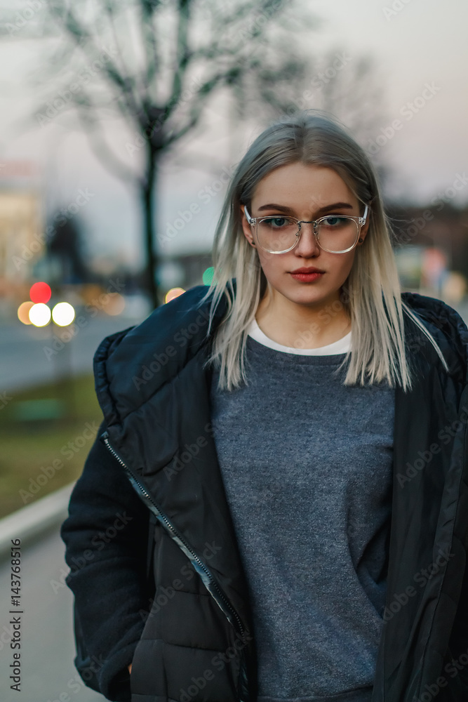 Beautiful attractive young girl in the evening in the city Beautiful attractive young girl in the evening in the city